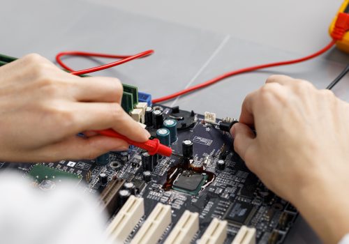 high-angle-female-technician-repairing-computer-motherboard